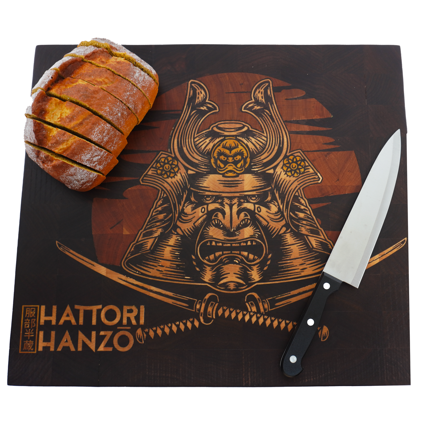 Flat lay of a Hattori Hanzo end grain cutting board used as a serving platter for rustic bread, highlighting the contrast between the dark walnut and the precision yellowheart sword inlay.