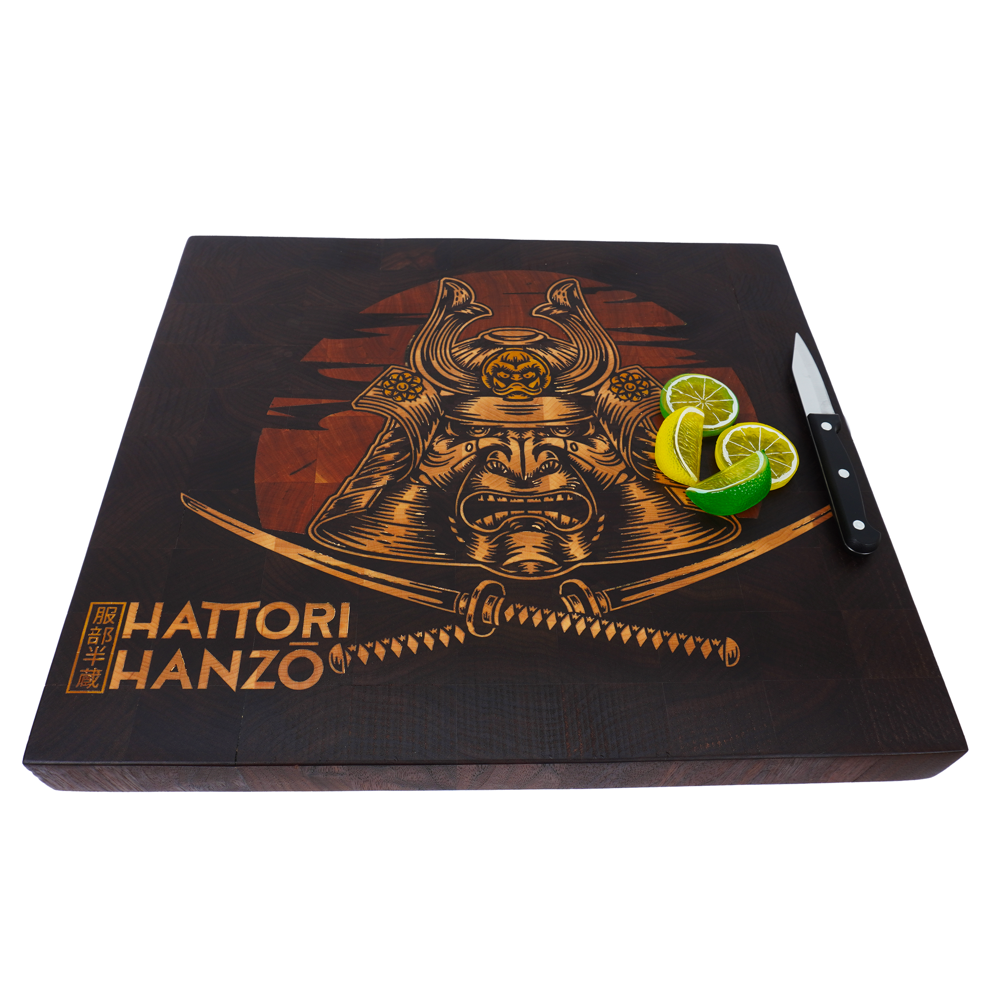 A 45-degree high-angle lifestyle shot of the Hattori Hanzo end grain cutting board, showcasing the structural integrity of the build with a small paring knife and citrus wedges to establish scale.
