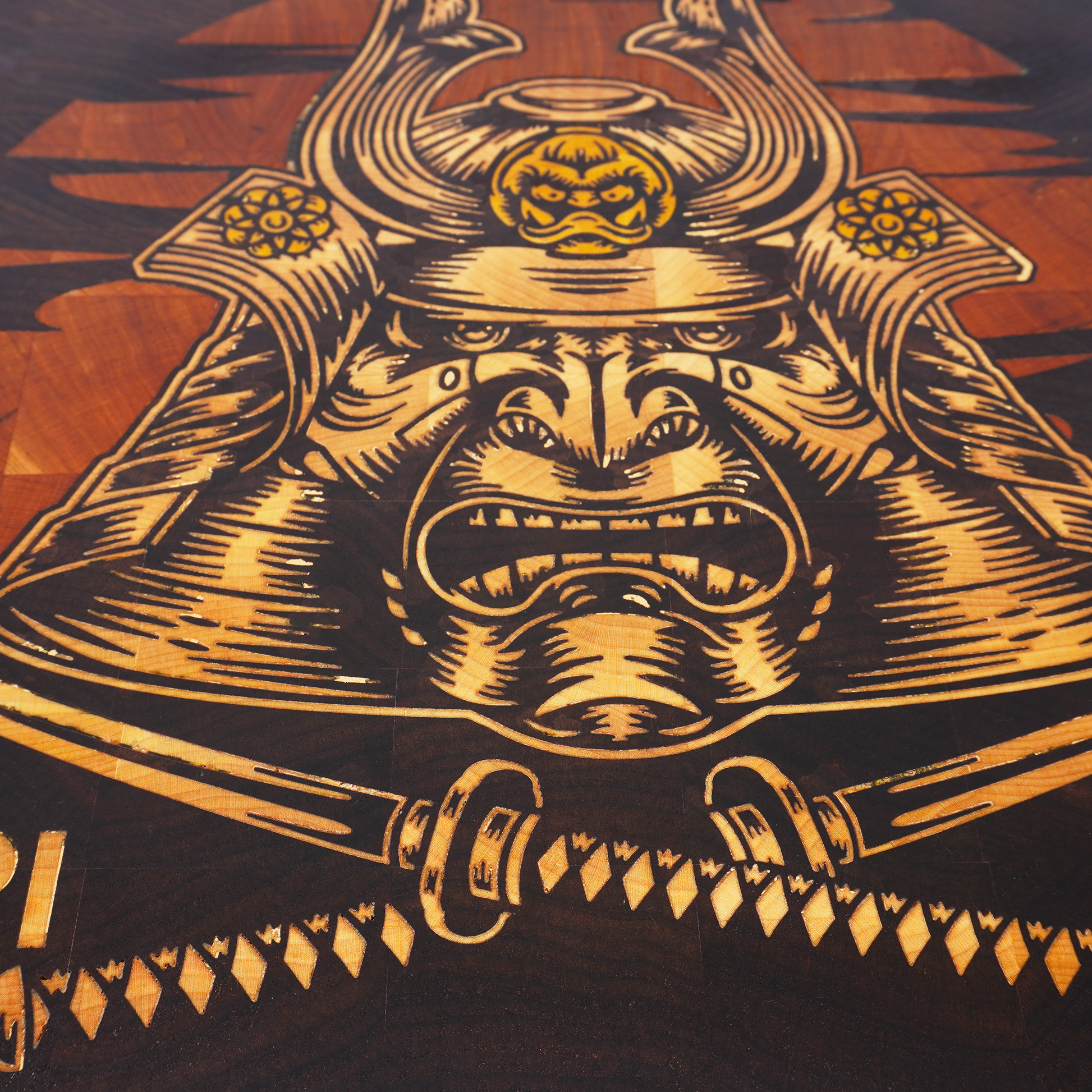 Macro detail of a Hattori Hanzo end grain cutting board showing the tight wood fibers of American black walnut and the seamless precision of the yellowheart sword inlay.