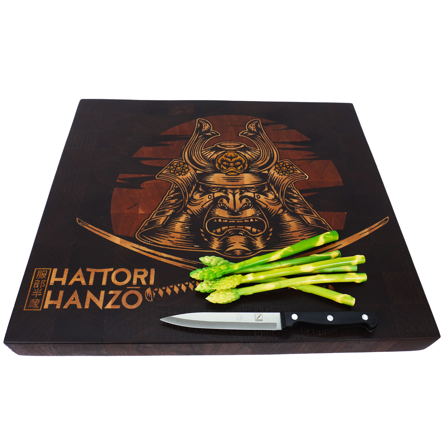 A 45-degree high-angle lifestyle shot of the Hattori Hanzo walnut end grain board with a chef's knife and asparagus, showcasing the board's thickness and artisan craftsmanship.