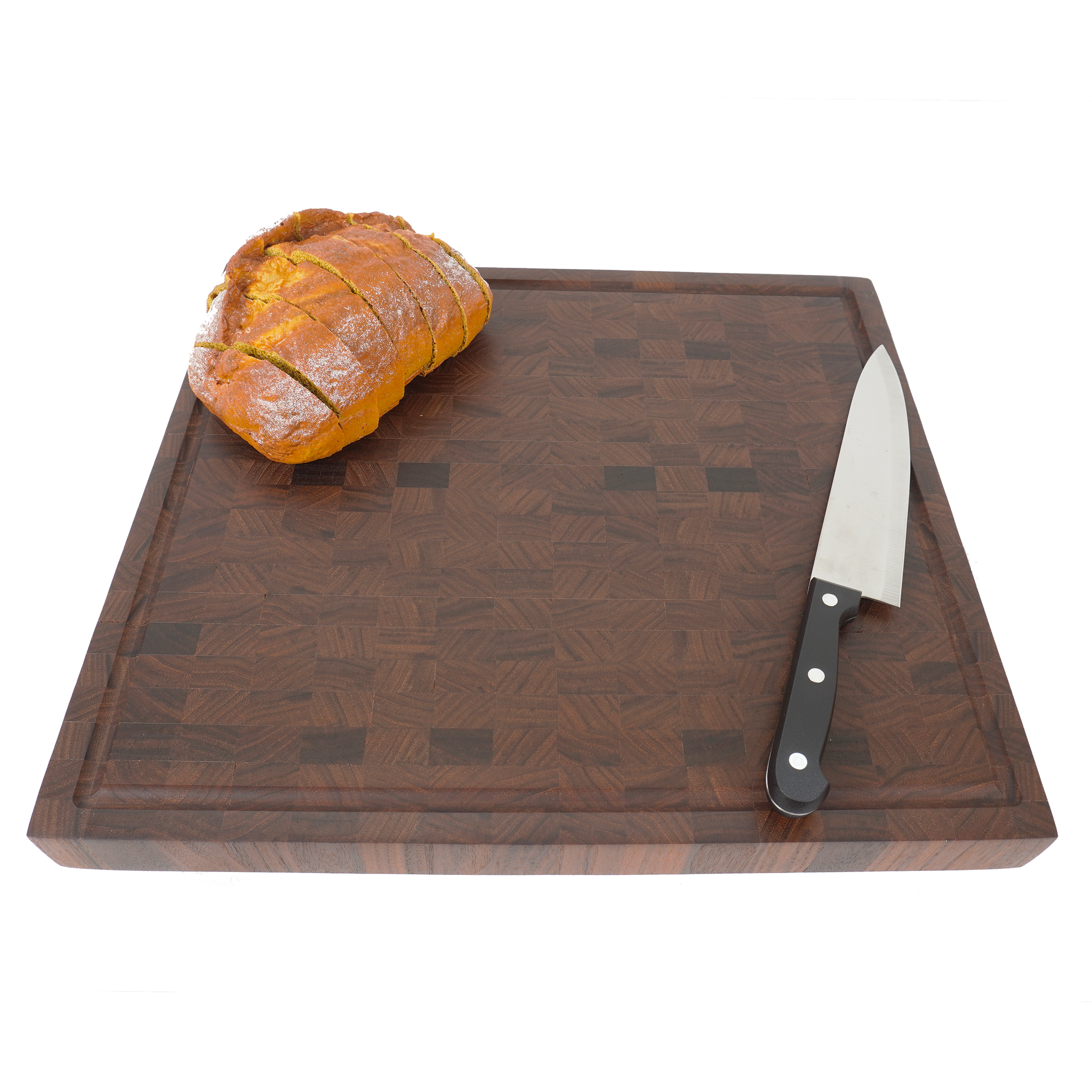 Angled shot of the walnut end grain board with bread, highlighting its versatility for both prep and presentation.