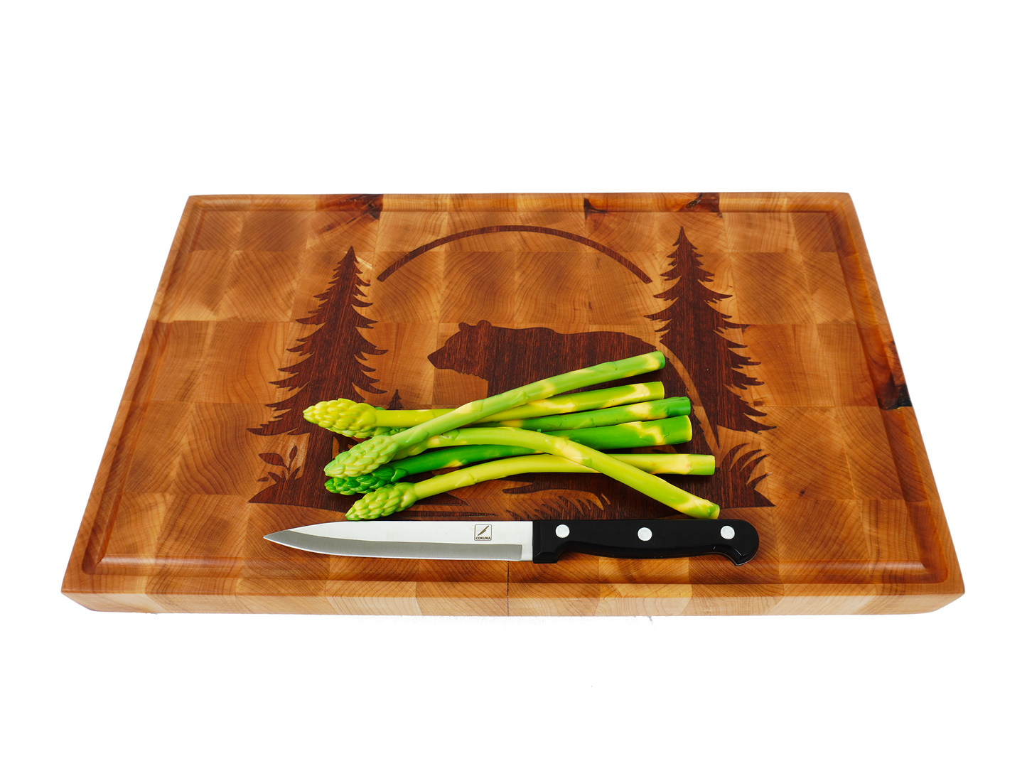 45-degree perspective of the Kodiak board staged with fresh asparagus in a kitchen setting.
