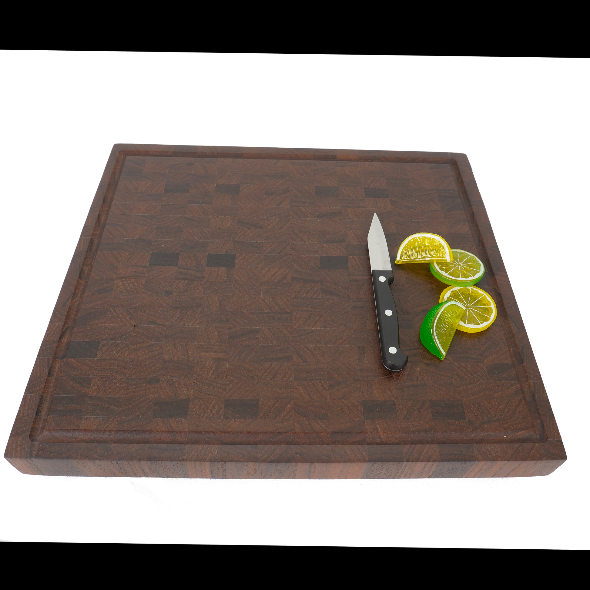 Angled view of the Heritage Series walnut board with sliced citrus, emphasizing the rich dark wood contrast.