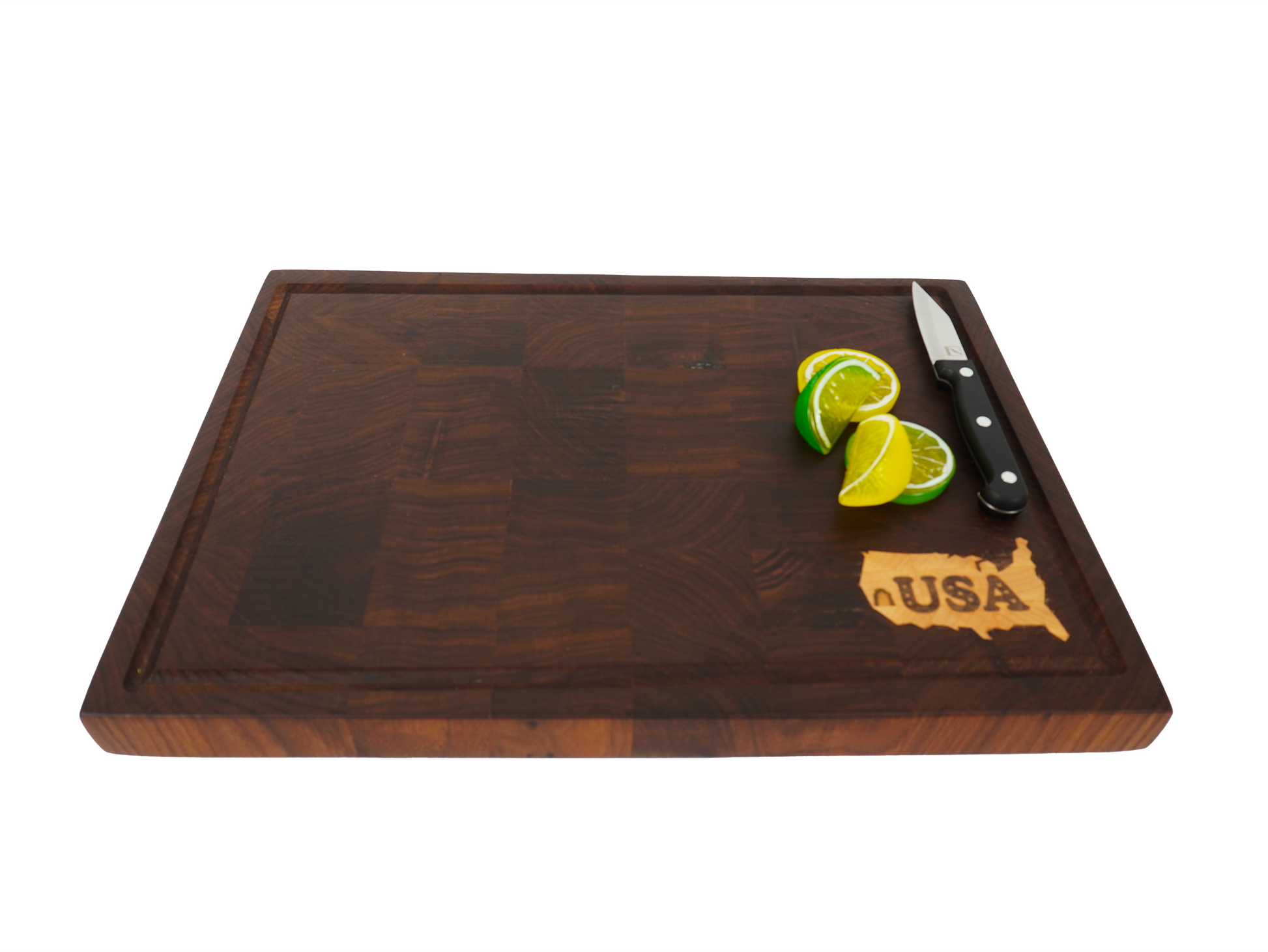 Angled view of the Patriot Sovereign walnut board being used for citrus preparation.