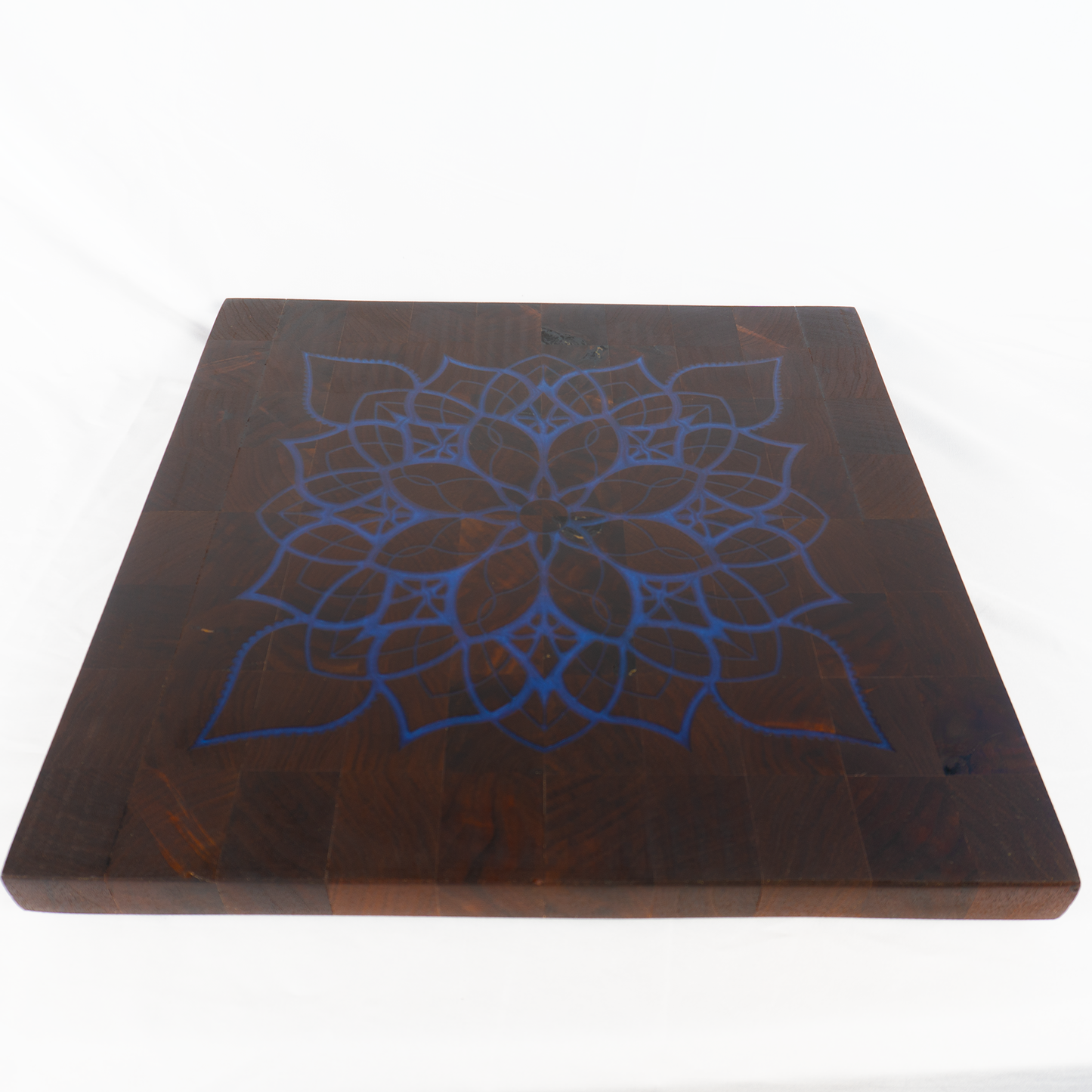 Walnut end grain cutting board navy blue epoxy mandala inlay angled view — Red Tail Boards