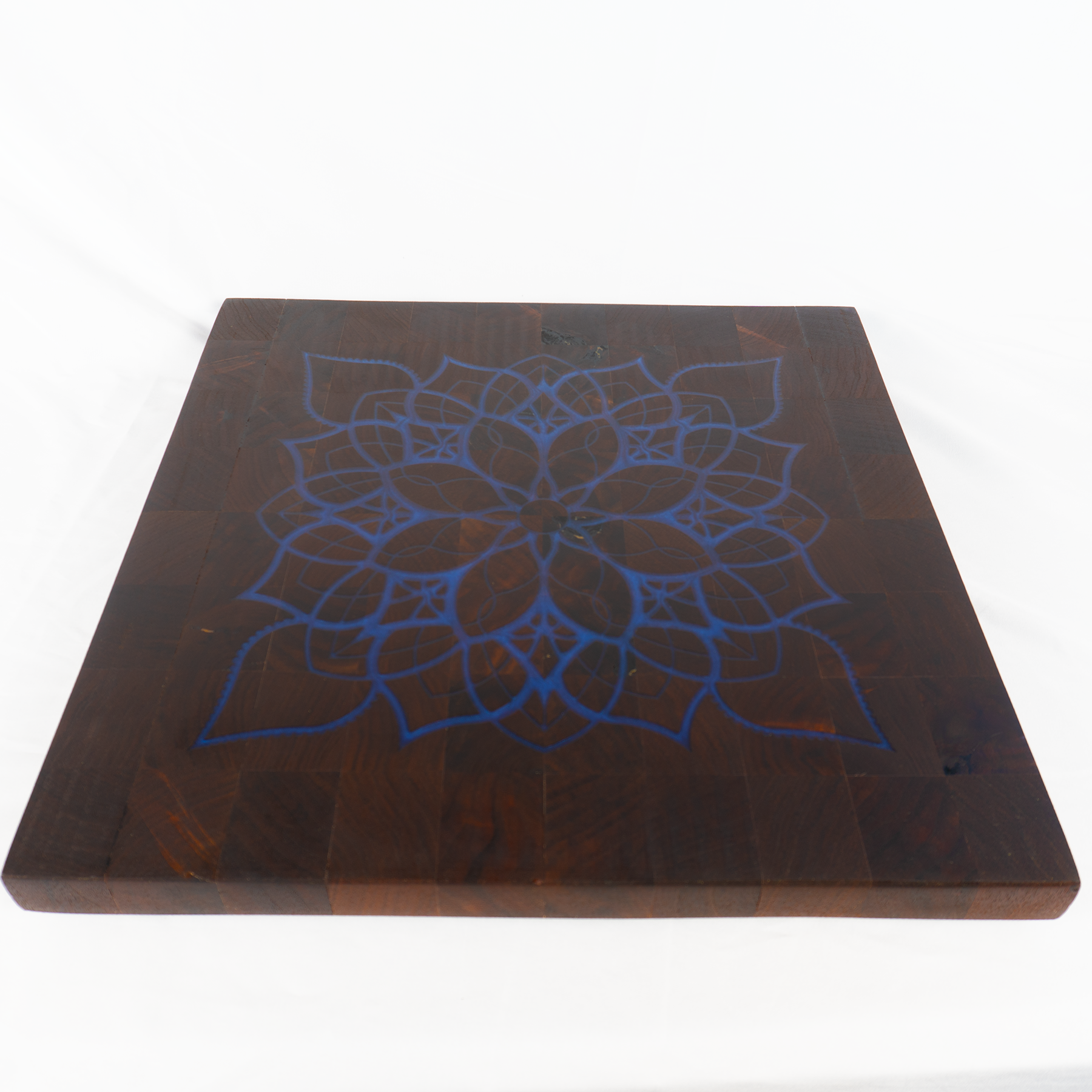 Walnut end grain cutting board navy blue epoxy mandala inlay angled view — Red Tail Boards