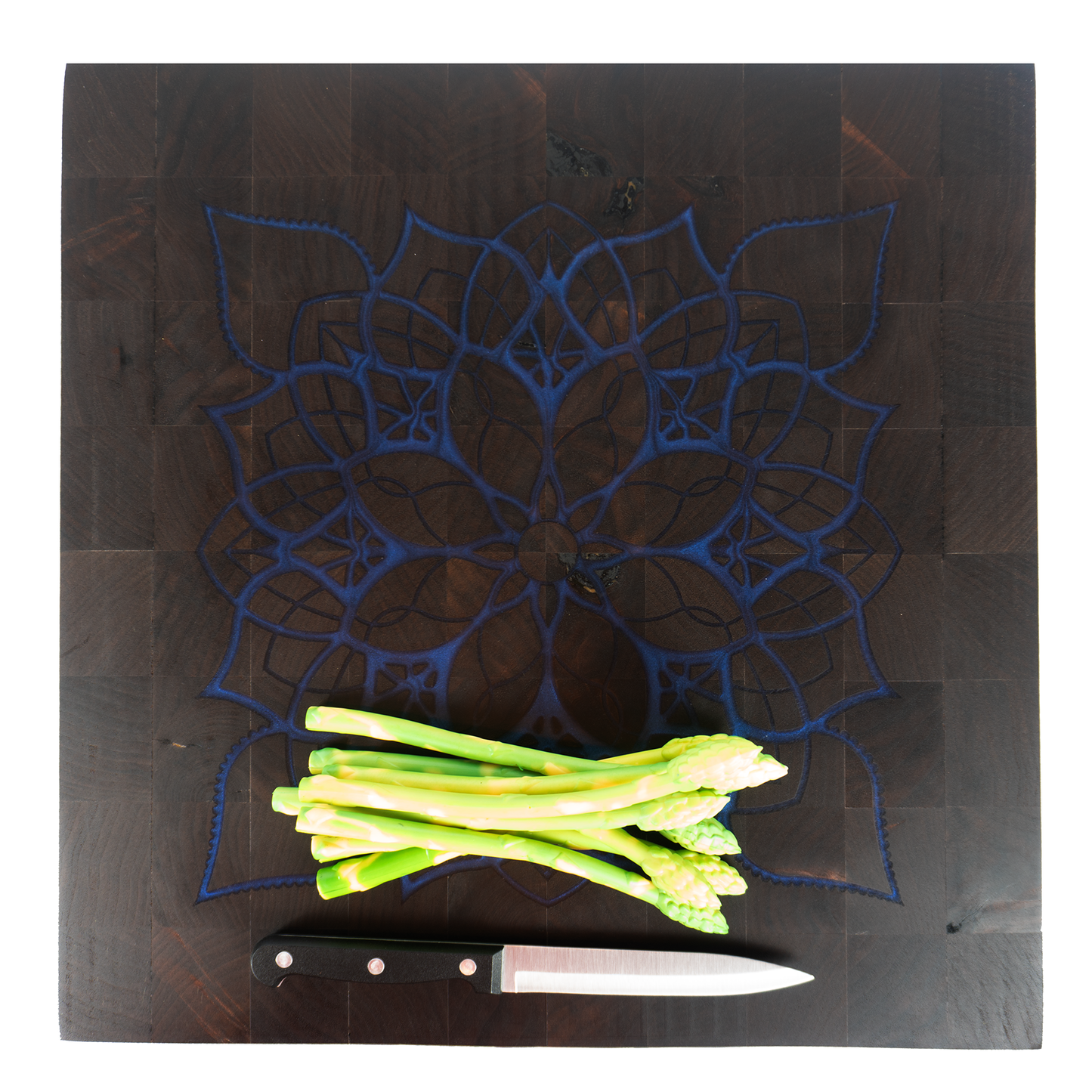 Walnut end grain blue epoxy mandala cutting board with asparagus and knife top view — Red Tail Boards
