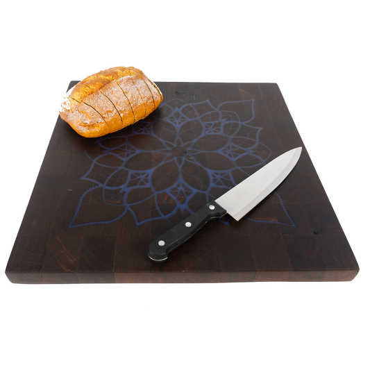 22x22 walnut end grain blue mandala inlay board with sliced bread and knife angled — Red Tail Boards