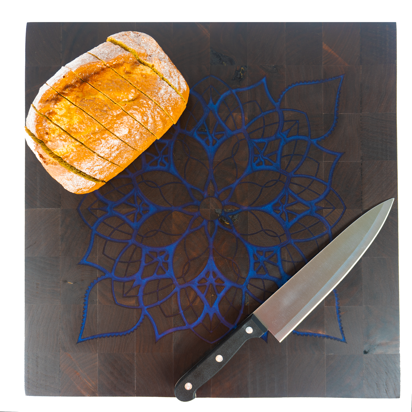Walnut end grain blue epoxy mandala cutting board with sliced bread and knife top view — Red Tail Boards