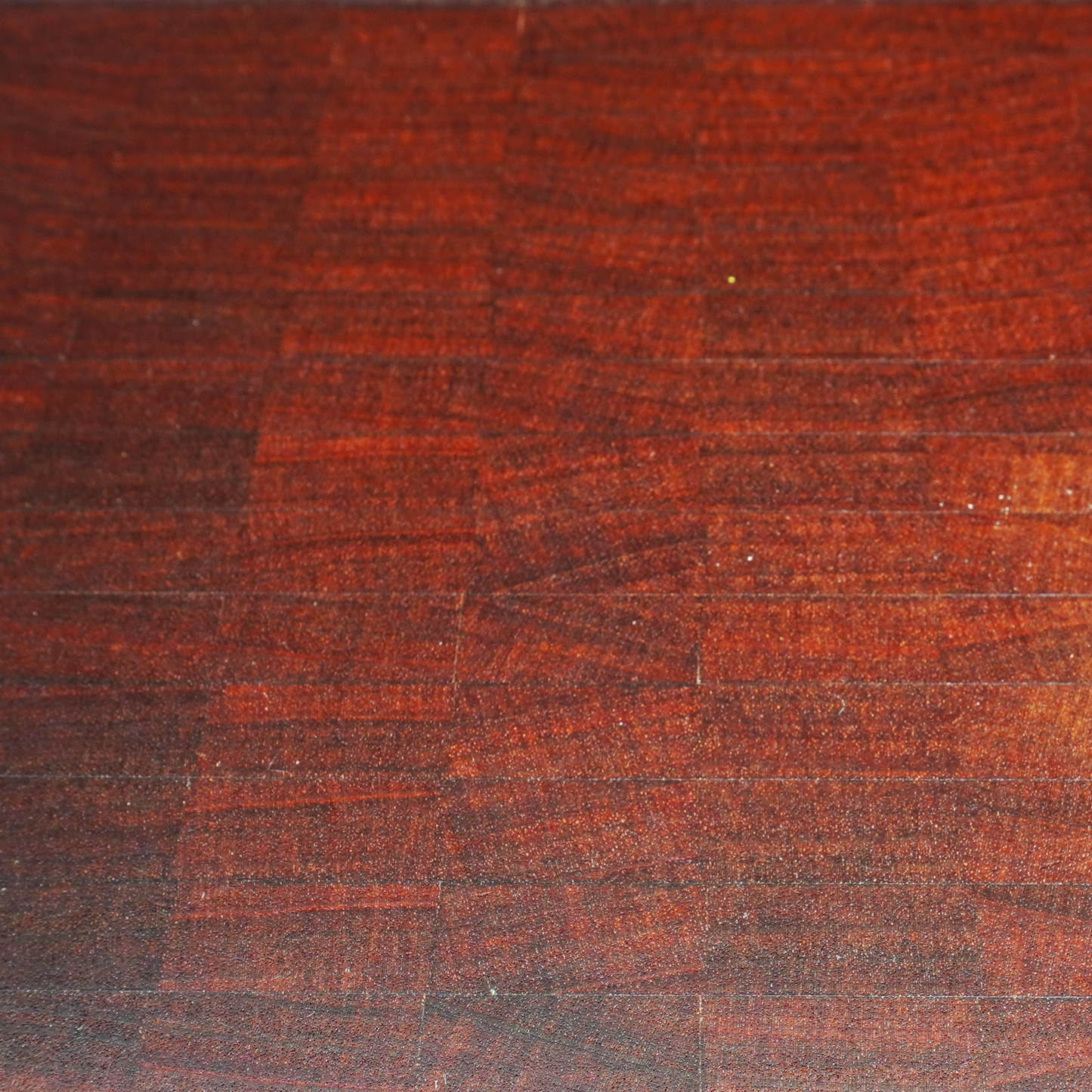 Macro shot of the self-healing Sapele end grain fibers and wood finish.