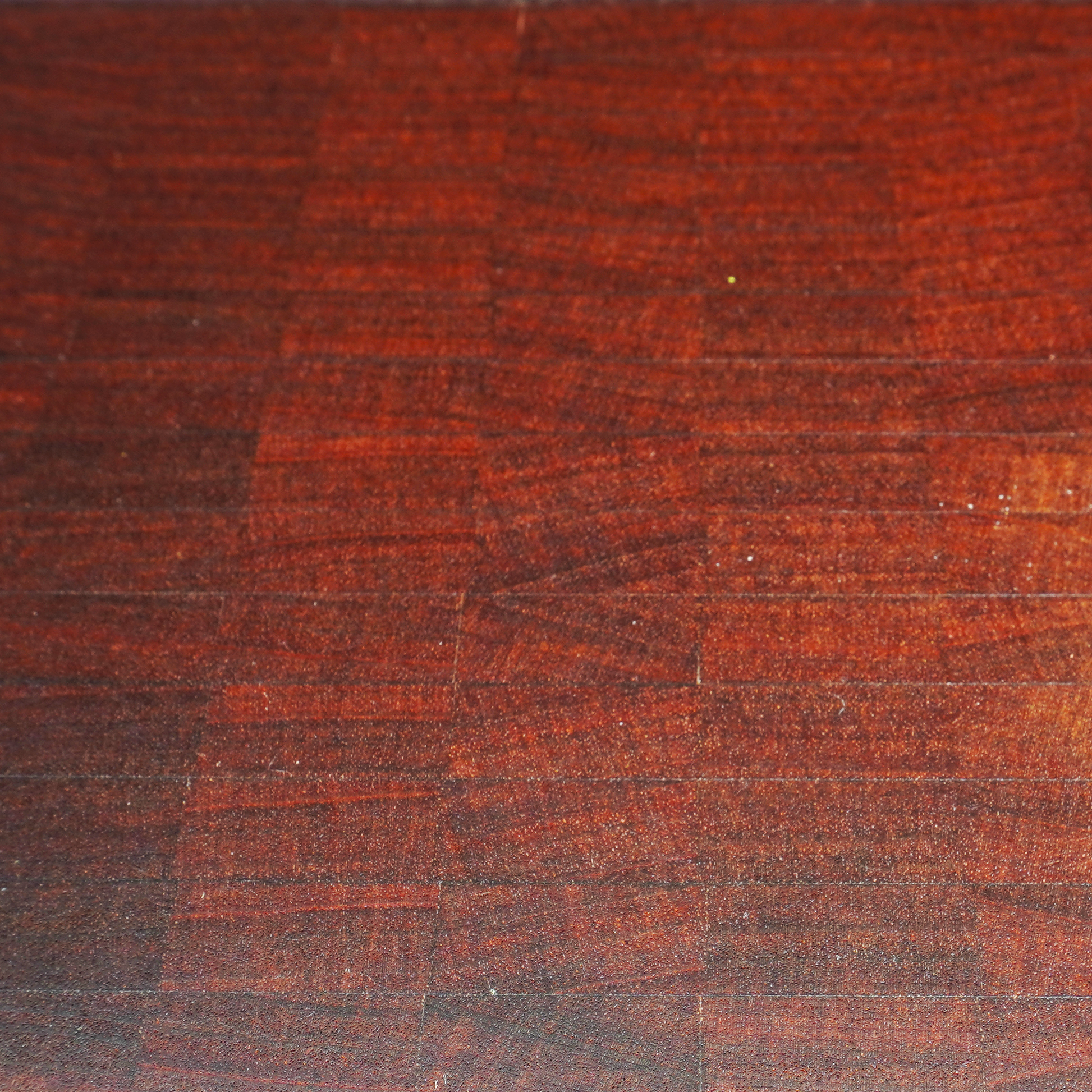 Macro shot of the self-healing Sapele end grain fibers and wood finish.