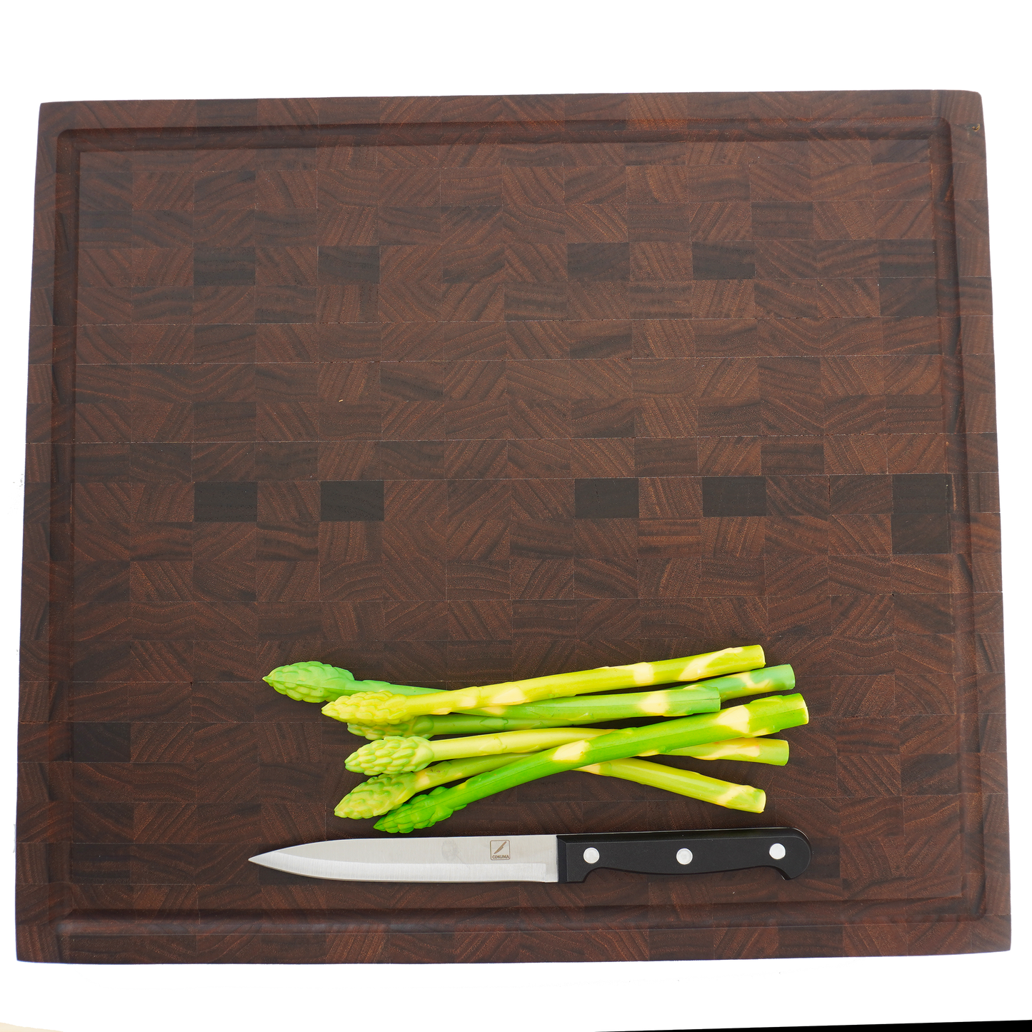 Level shot of asparagus on a walnut end grain board, highlighting its use as a professional chef's prep station.