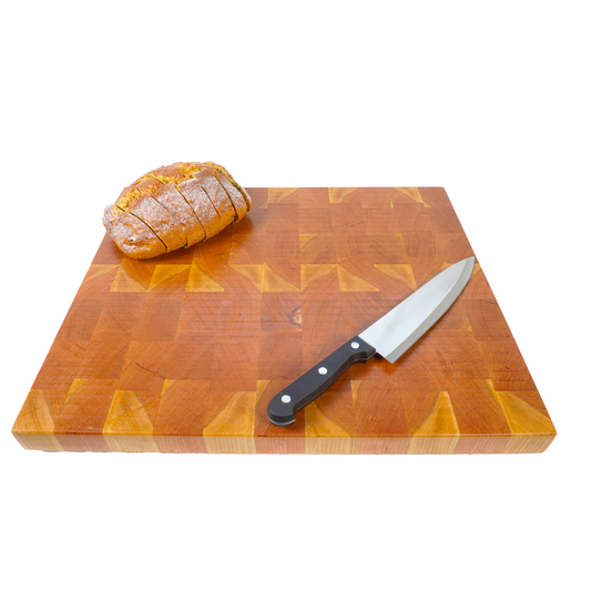 Cherry end grain cutting board with sliced bread and knife, 45 degree angle