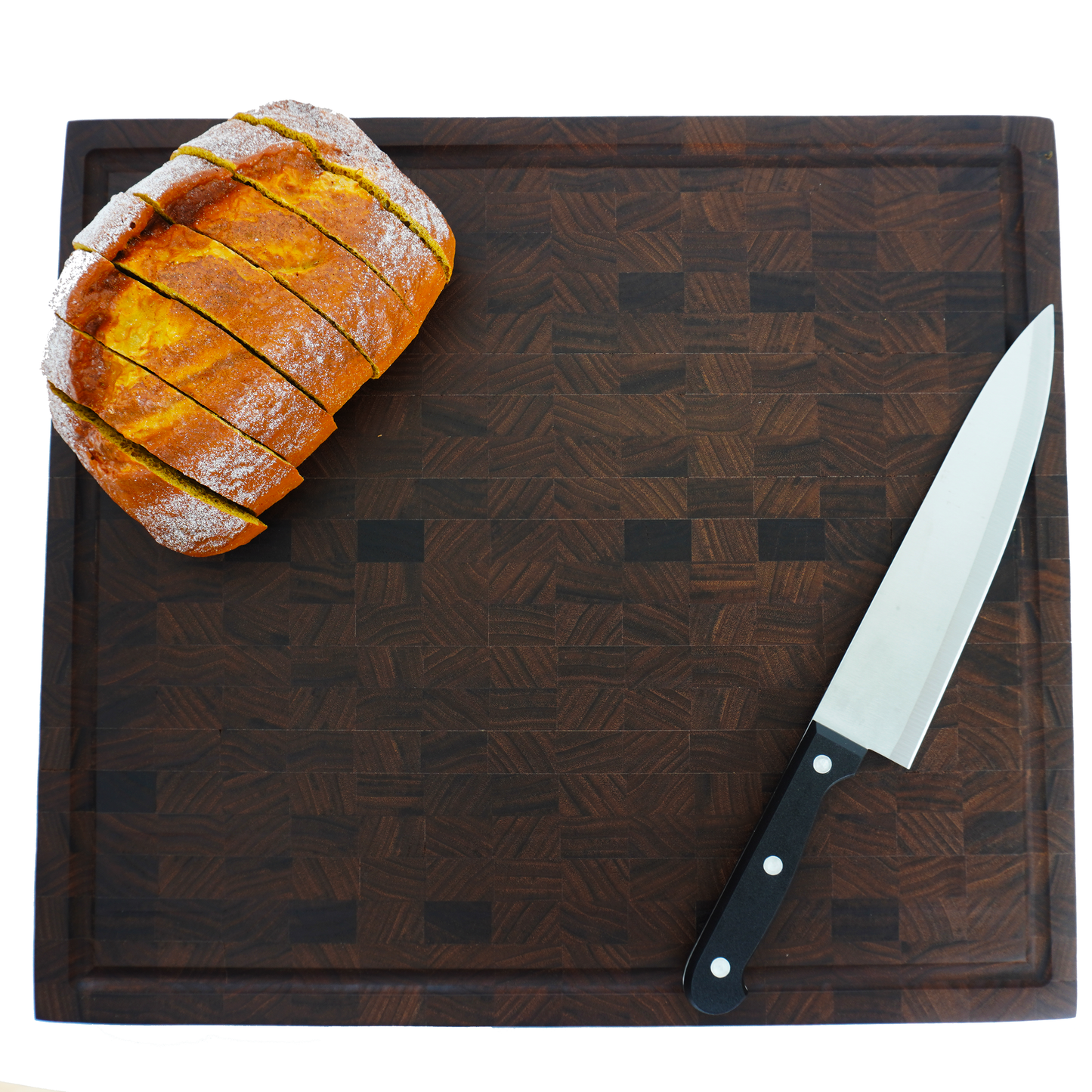 Horizontal view of a rustic loaf on the Sovereign walnut board, functioning as a high-end serving centerpiece.