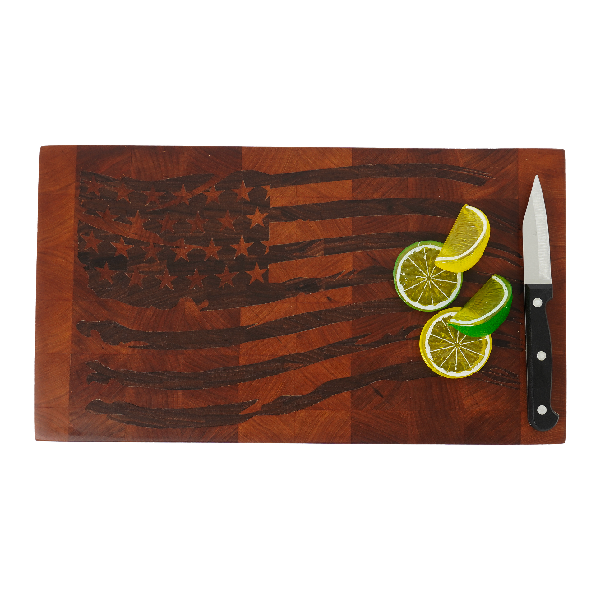 Tattered Glory Sovereign end grain cutting board top down with lemons limes and knife, American flag walnut inlay maple cutting board in use